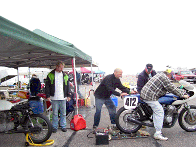 Tim V's starter system is much in demand, Justin is starting his bike in this photo
