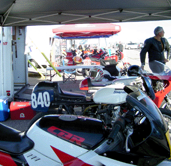 looking down the pit row over a sea of delightful racing equipment